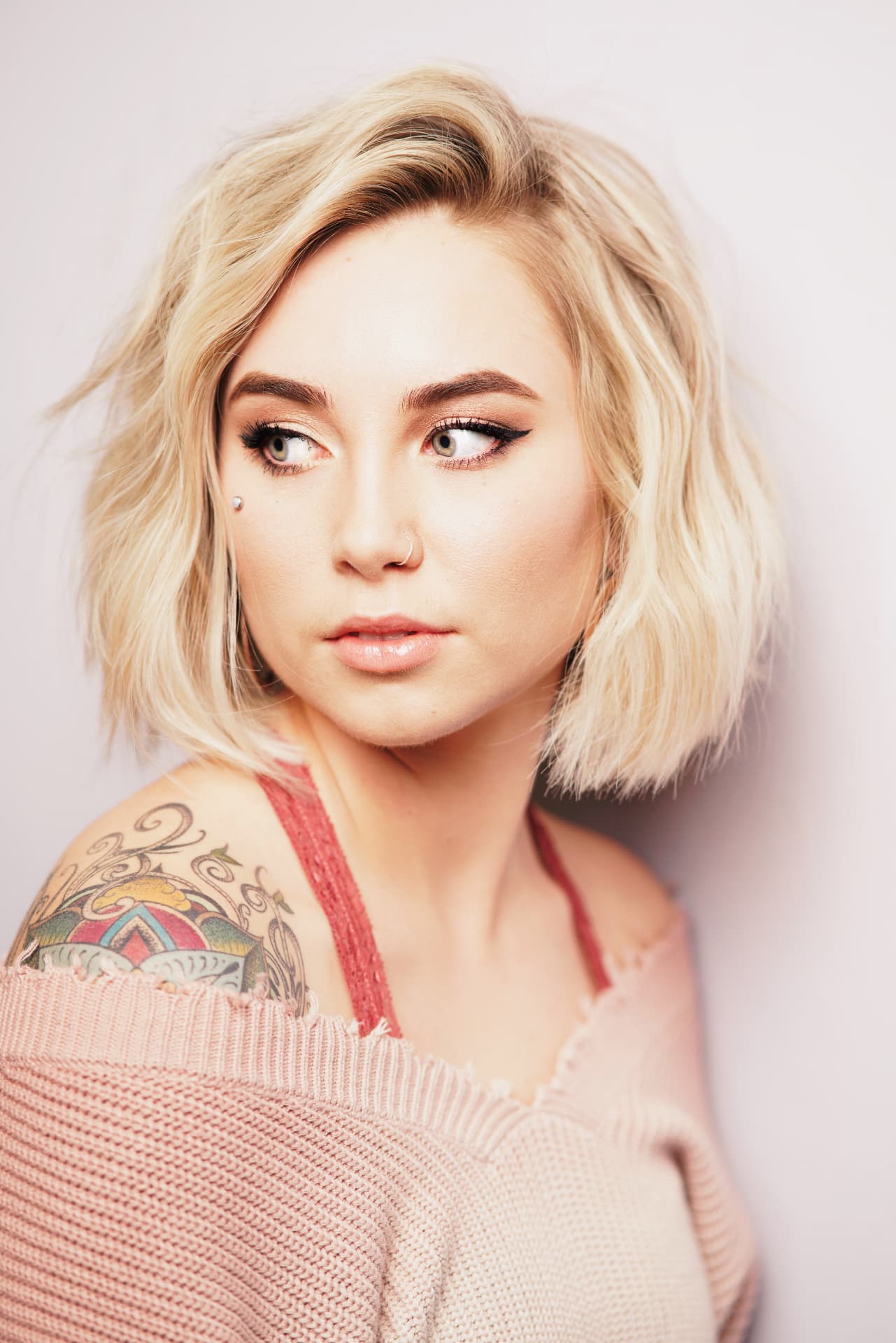 Platinum blonde tousled bob with a side part